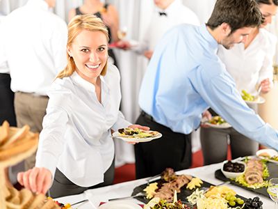 woman eating food from buffet